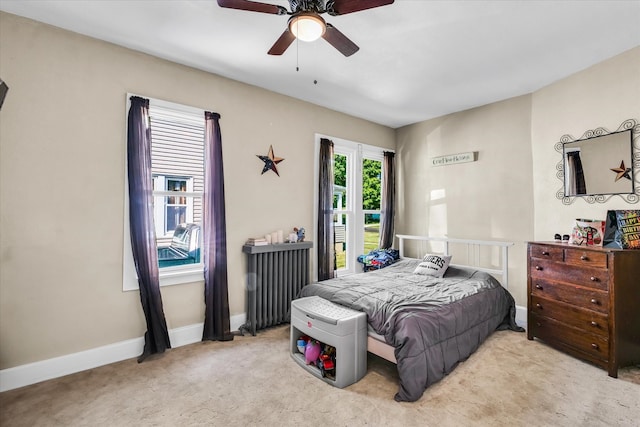 carpeted bedroom featuring radiator heating unit and ceiling fan