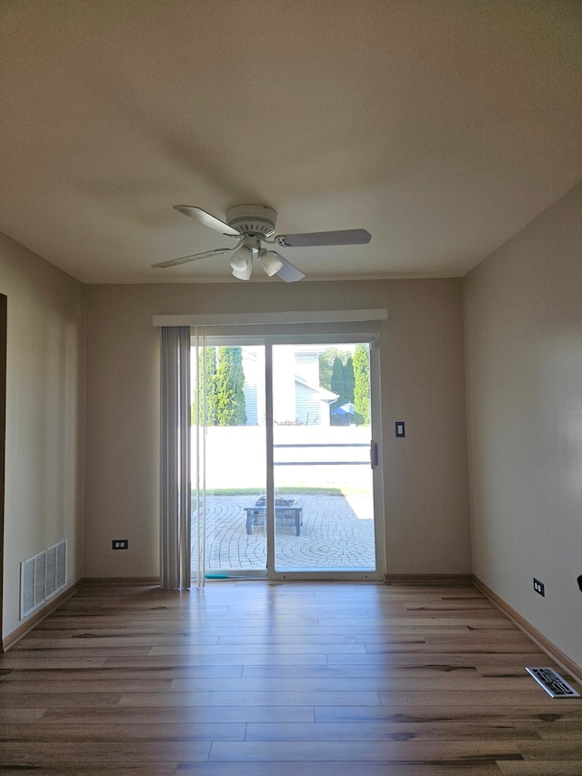 spare room featuring light hardwood / wood-style flooring and ceiling fan