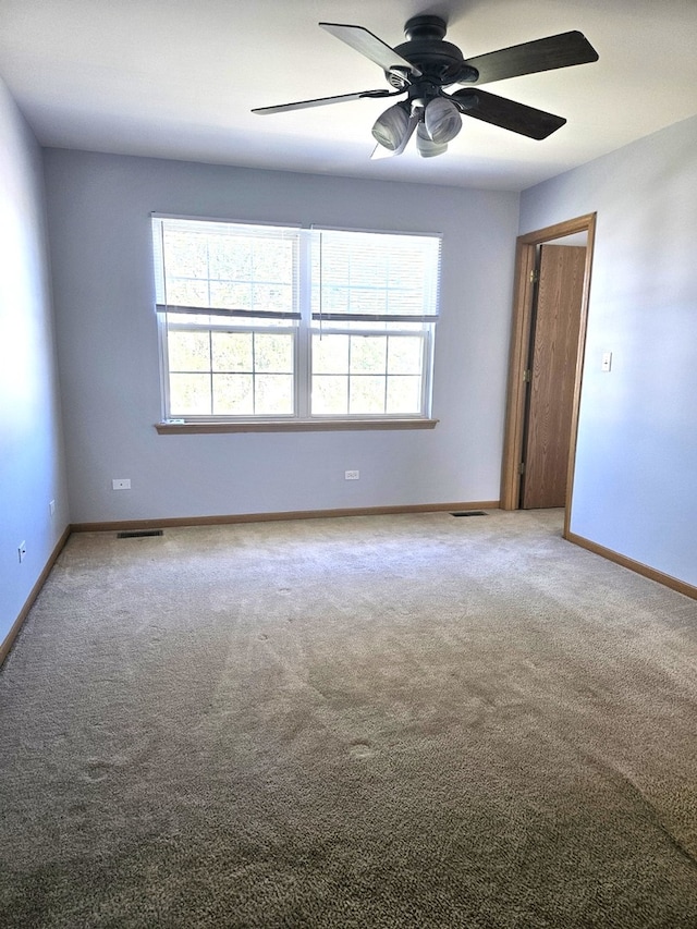 unfurnished room featuring ceiling fan and carpet floors