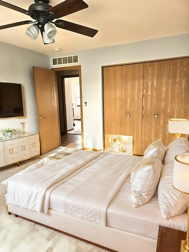 bedroom with ceiling fan and a closet