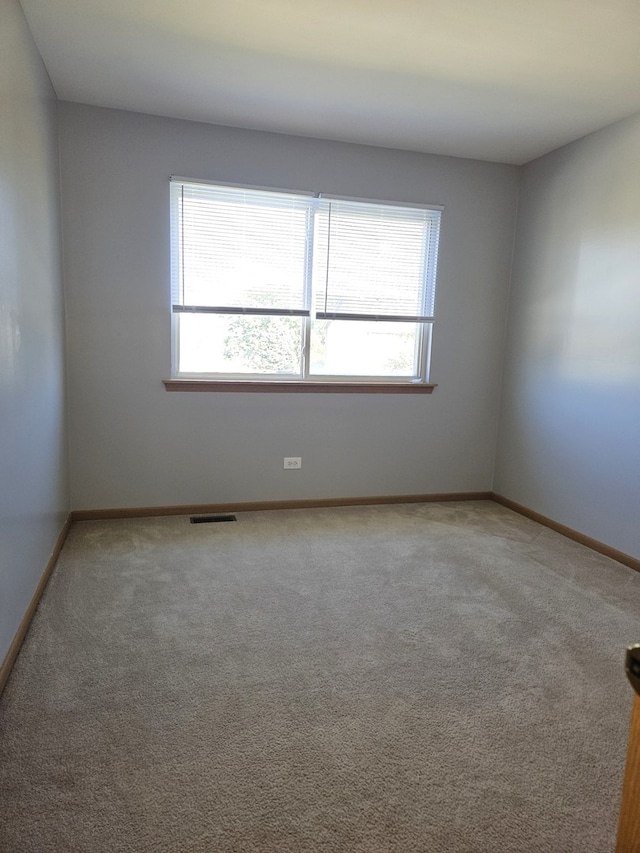 spare room featuring carpet