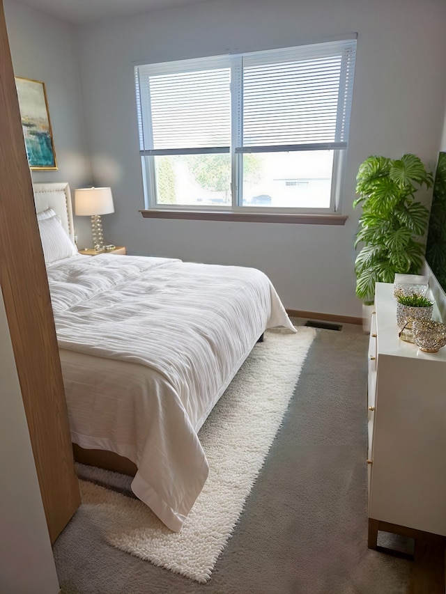 carpeted bedroom featuring multiple windows