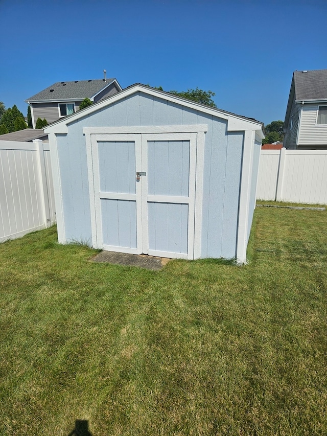 view of outbuilding with a lawn