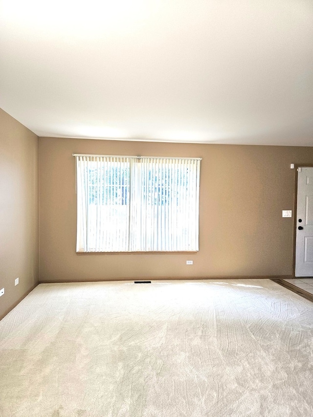 empty room featuring light carpet