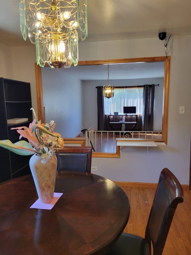 dining space with an inviting chandelier and hardwood / wood-style floors