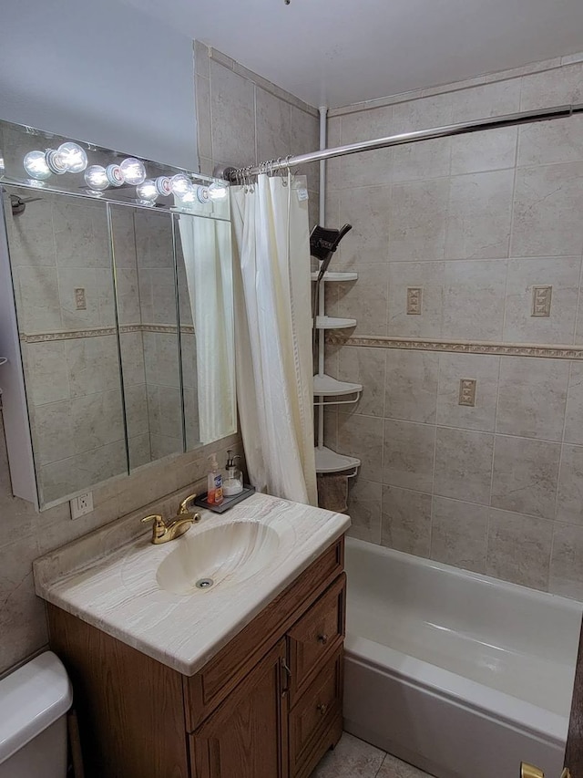 full bathroom featuring vanity, tile patterned flooring, toilet, and shower / bath combo