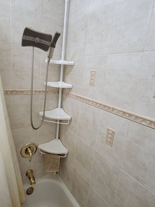 interior details with tiled shower / bath combo