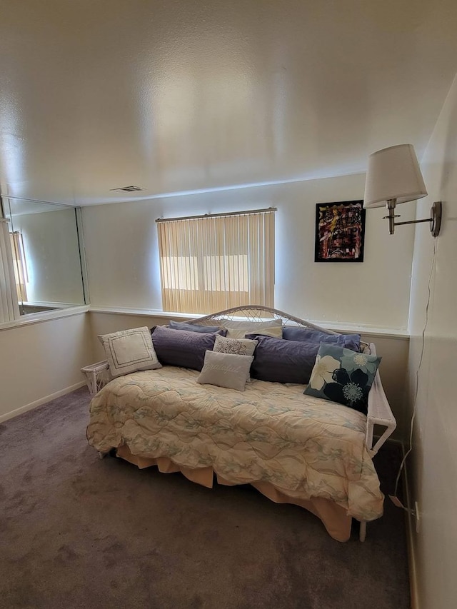 bedroom featuring dark carpet