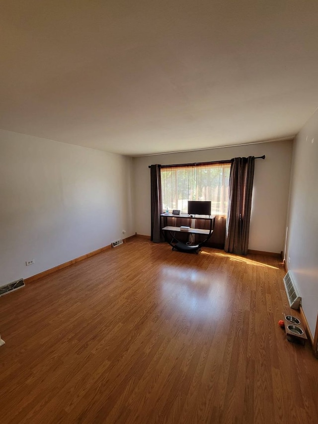 unfurnished living room featuring hardwood / wood-style flooring