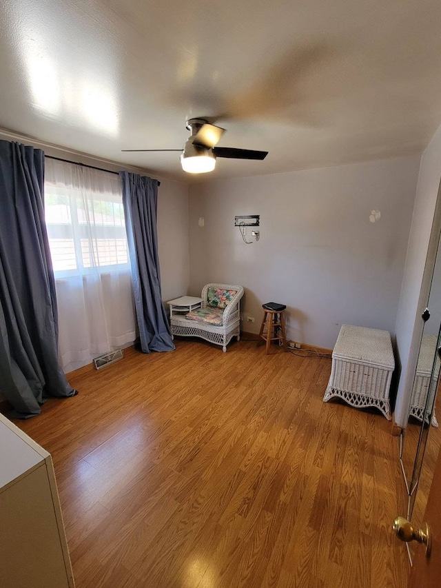 unfurnished bedroom with ceiling fan and hardwood / wood-style flooring