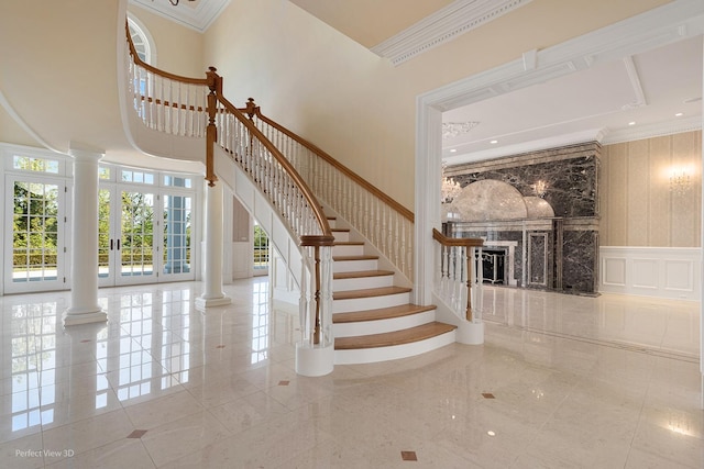 344 Old Sutton Rd, Barrington, IL 60010 - stairway with a decorative wall, a high ceiling, a fireplace, decorative columns, and ornamental molding