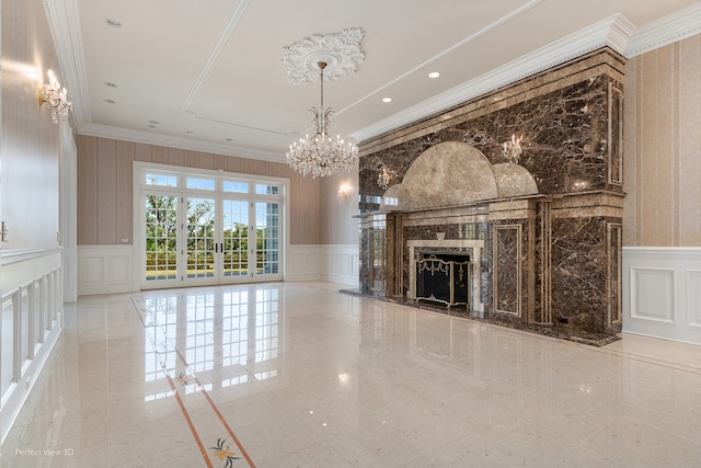 unfurnished living room with an inviting chandelier, a fireplace, and crown molding