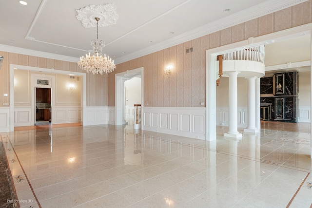 tiled empty room featuring a notable chandelier, ornate columns, and crown molding