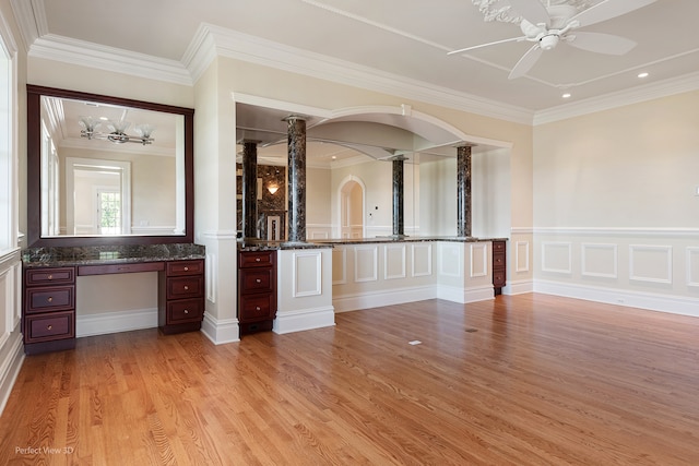 interior space with built in desk, ornamental molding, ceiling fan, and light hardwood / wood-style flooring