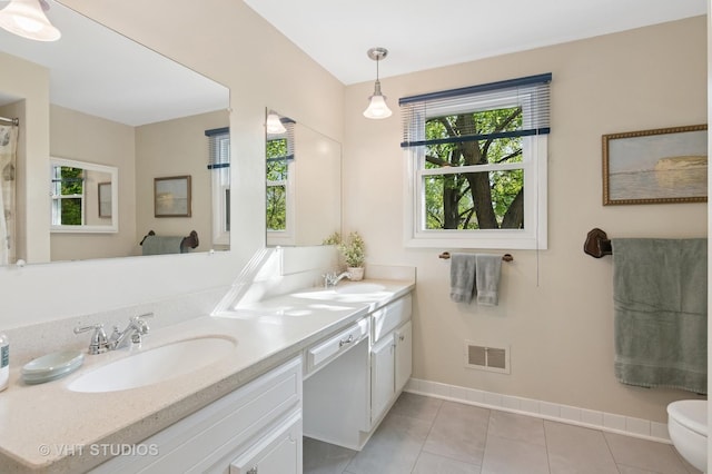 945 N Stark Dr, Palatine, IL 60074 - bathroom featuring baseboards, double vanity, tile patterned flooring, toilet, and a shower