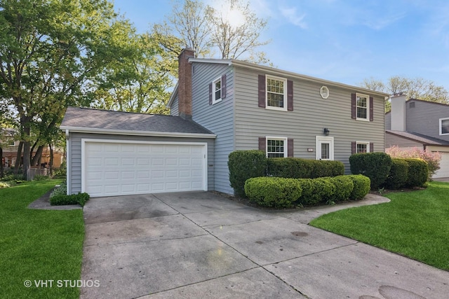 945 N Stark Dr, Palatine, IL 60074 - view of front facade featuring concrete driveway, a front yard, a chimney, and a garage