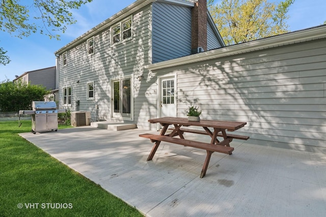 945 N Stark Dr, Palatine, IL 60074 - back of property with a patio, a chimney, cooling unit, and a lawn