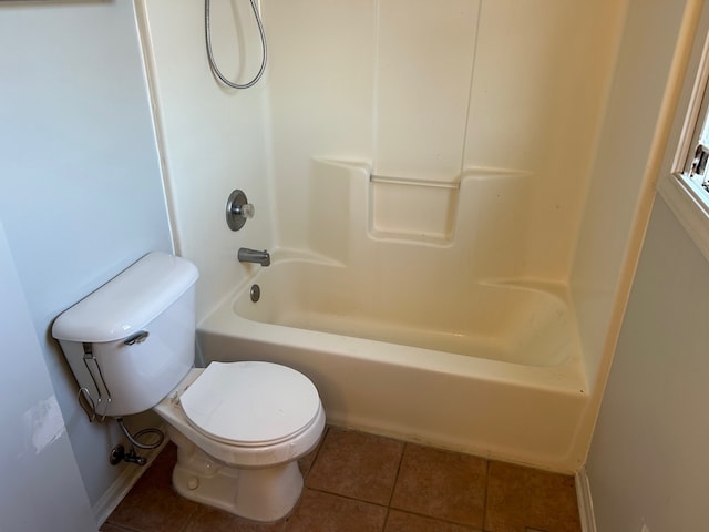 bathroom featuring tub / shower combination, tile patterned flooring, and toilet