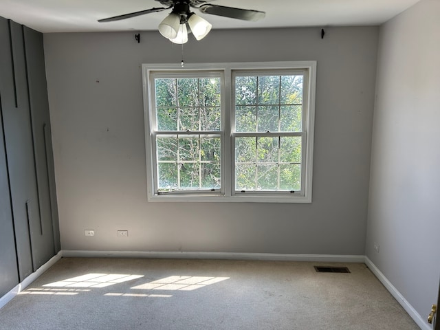 empty room featuring carpet and ceiling fan