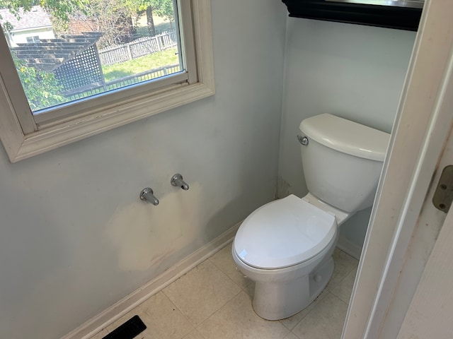 bathroom with toilet and tile patterned floors