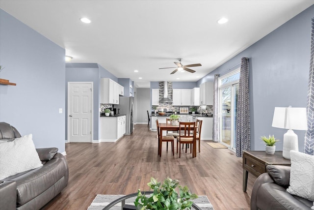 living room featuring hardwood / wood-style flooring and ceiling fan