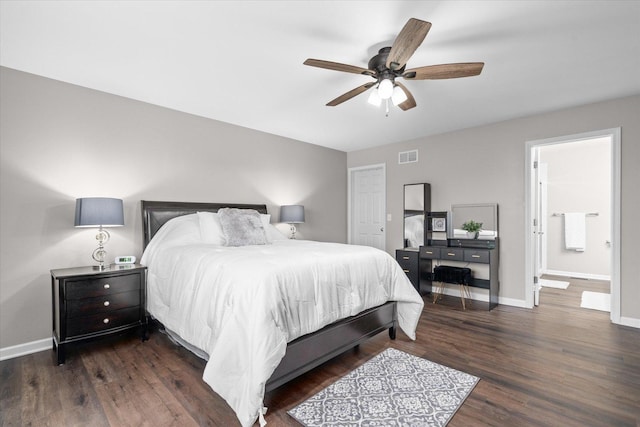 bedroom with dark hardwood / wood-style flooring, ensuite bath, and ceiling fan