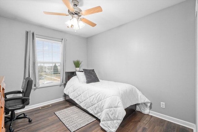 bedroom with dark hardwood / wood-style floors and ceiling fan