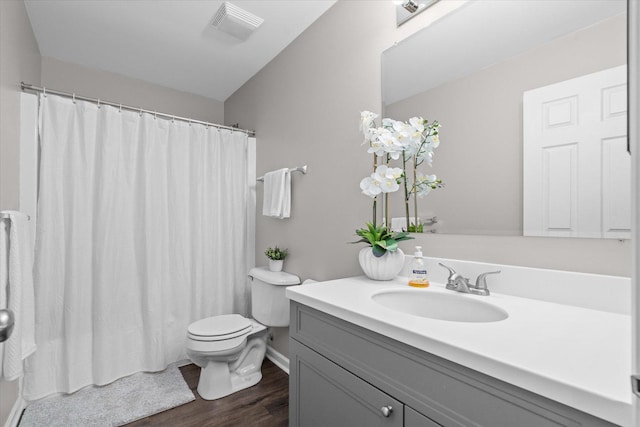 bathroom featuring vanity, wood-type flooring, and toilet