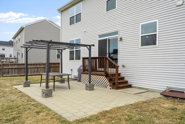 back of property with a yard, a pergola, and a patio area