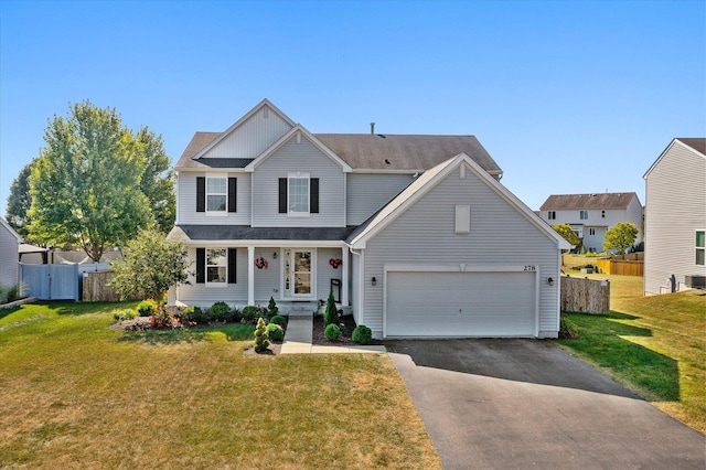 view of front of house featuring a garage and a front lawn