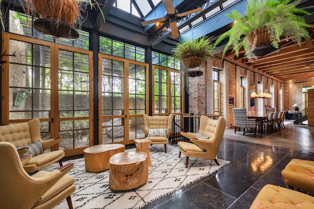 interior space with ceiling fan and a skylight