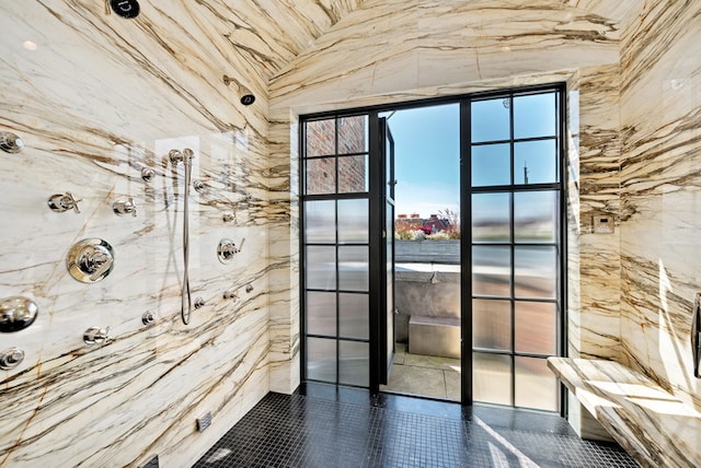 doorway to outside with dark tile patterned floors