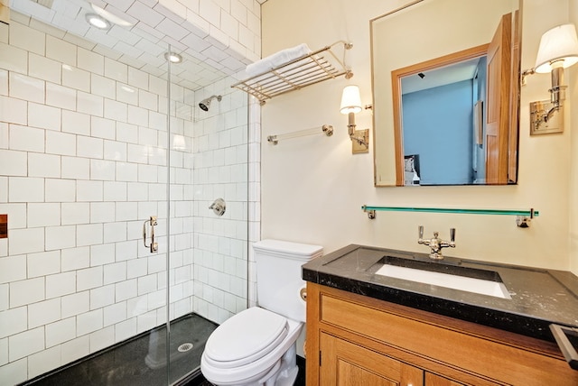 bathroom with walk in shower, vanity, and toilet