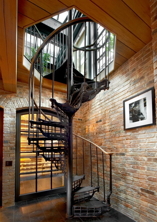 staircase with brick wall