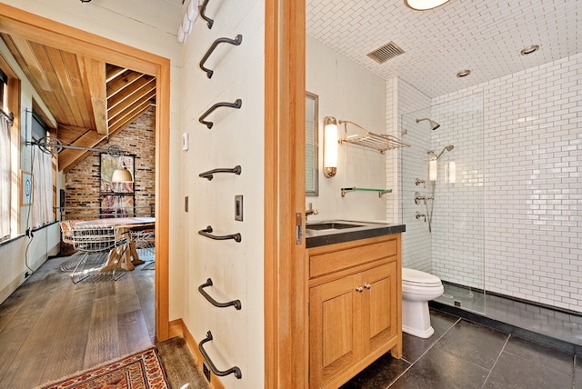 bathroom featuring walk in shower, hardwood / wood-style flooring, vanity, and toilet