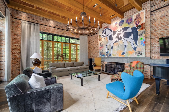 living room featuring brick wall, beamed ceiling, wooden ceiling, an inviting chandelier, and hardwood / wood-style flooring