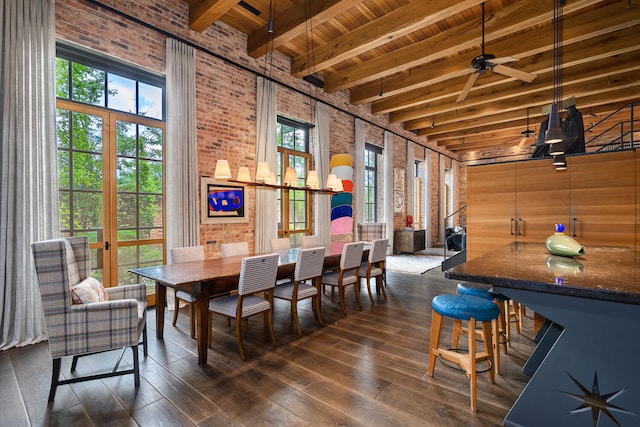 dining area featuring ceiling fan, beamed ceiling, french doors, brick wall, and dark hardwood / wood-style flooring