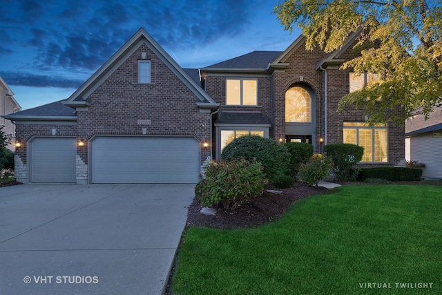 front of property featuring a yard and a garage