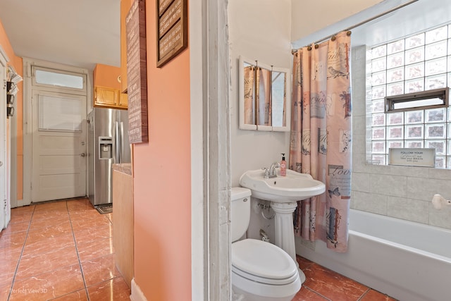 bathroom featuring tile patterned flooring, shower / bathtub combination with curtain, and toilet