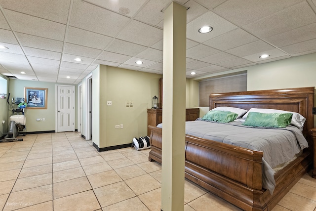 bedroom with light tile patterned flooring and a paneled ceiling