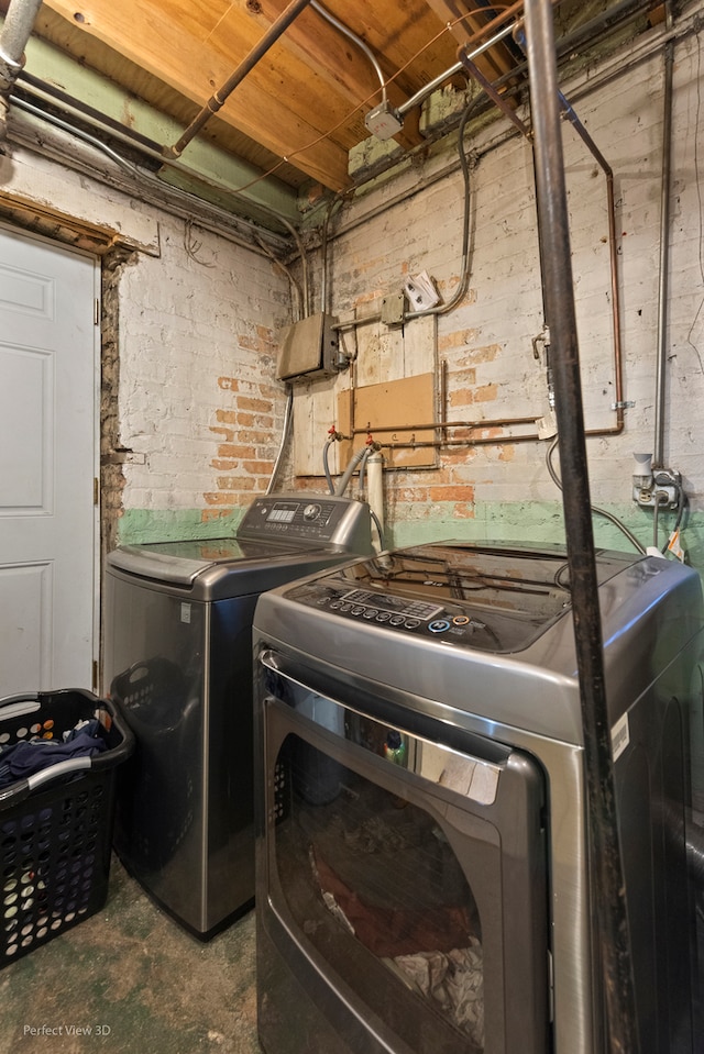 clothes washing area featuring independent washer and dryer