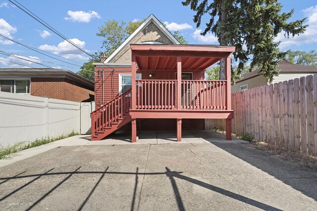 rear view of house featuring a deck