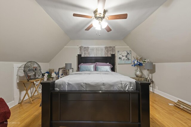 bedroom with vaulted ceiling, hardwood / wood-style floors, and ceiling fan