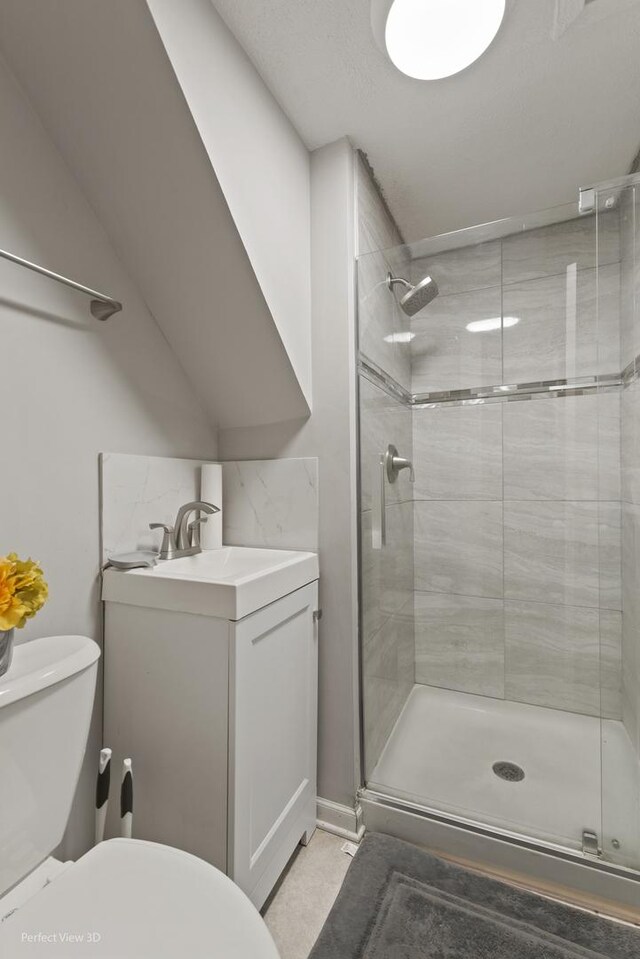 bathroom featuring a shower with shower door, vanity, and toilet