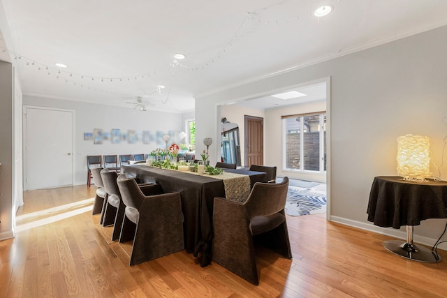 dining room featuring light hardwood / wood-style flooring and ornamental molding