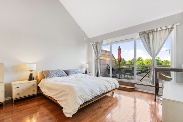 bedroom featuring high vaulted ceiling, access to outside, and hardwood / wood-style floors