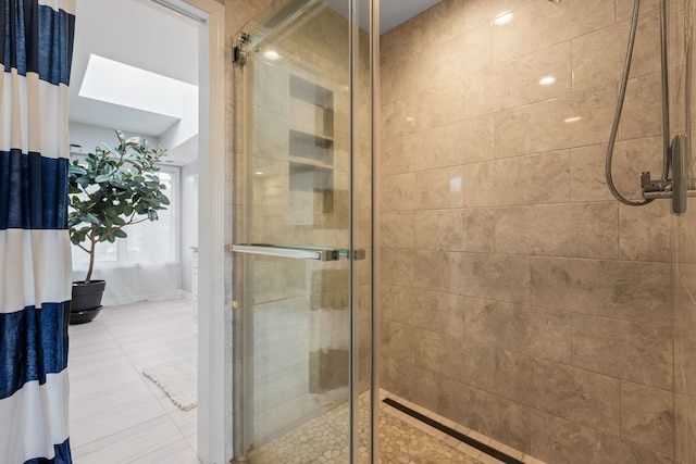 bathroom featuring walk in shower and tile patterned floors