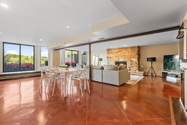 dining room featuring tile patterned floors and a fireplace