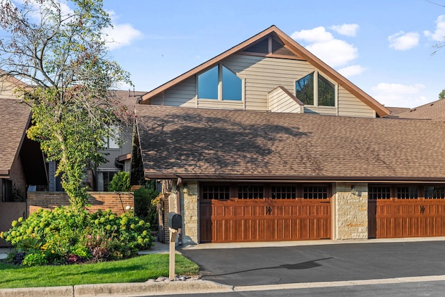 1204 Hawthorne Ln, Hinsdale, IL 60521 - view of front of home with an attached garage, a shingled roof, stone siding, and aphalt driveway