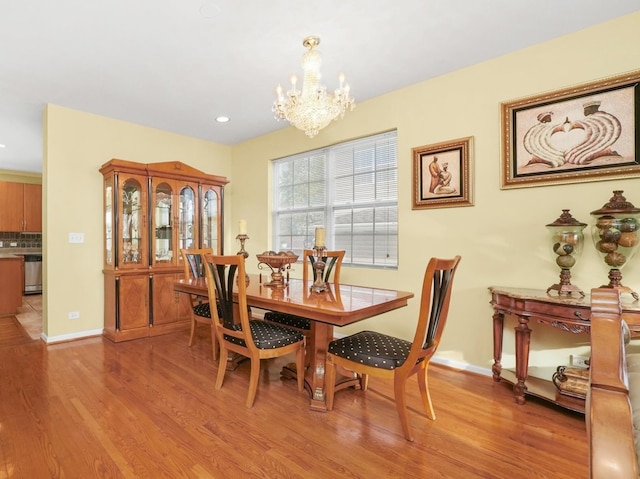 dining room featuring an inviting chandelier and light wood-type flooring